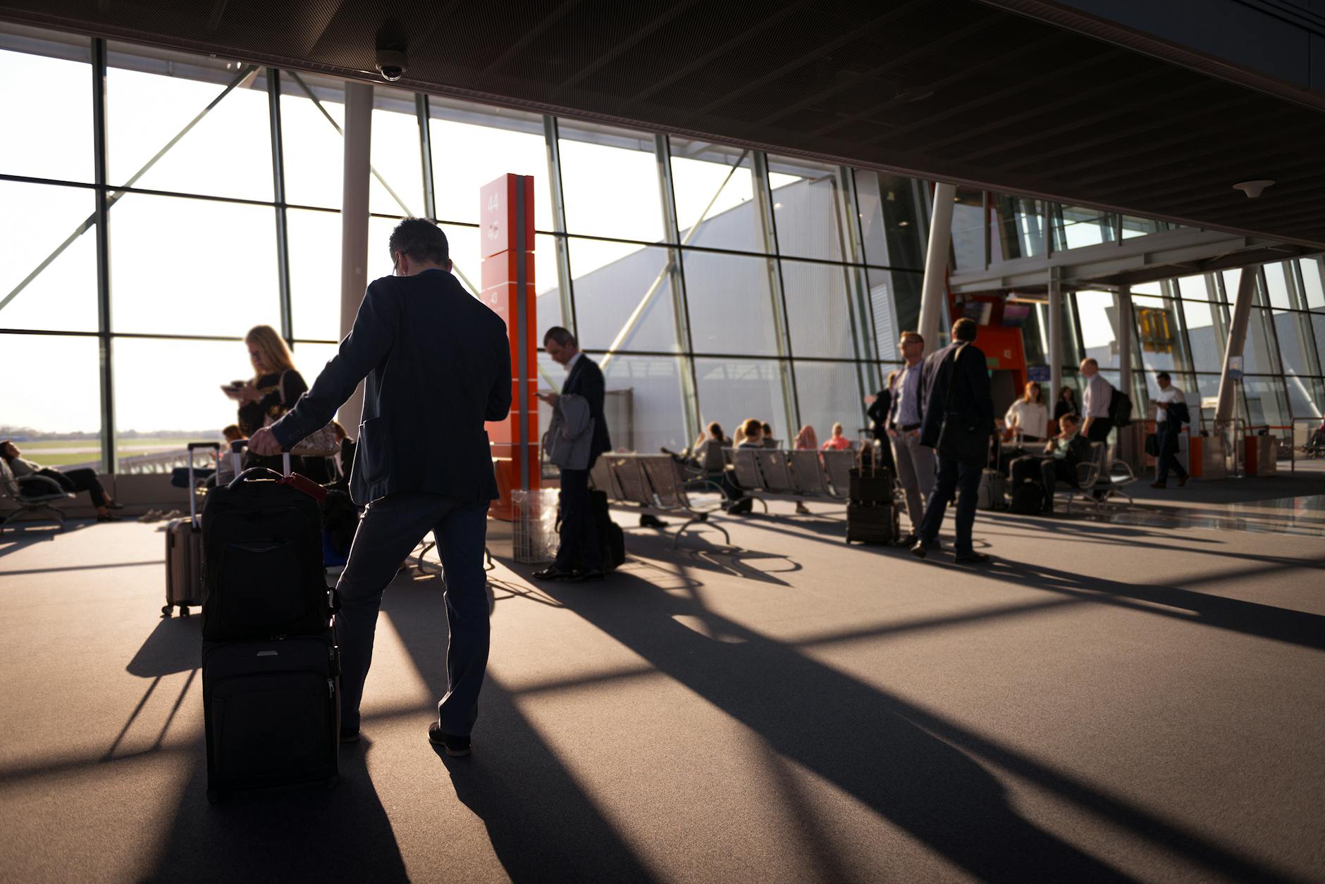 Travelers with luggage at airport terminal, Chicago limo service to ORD, MDW, MKE
