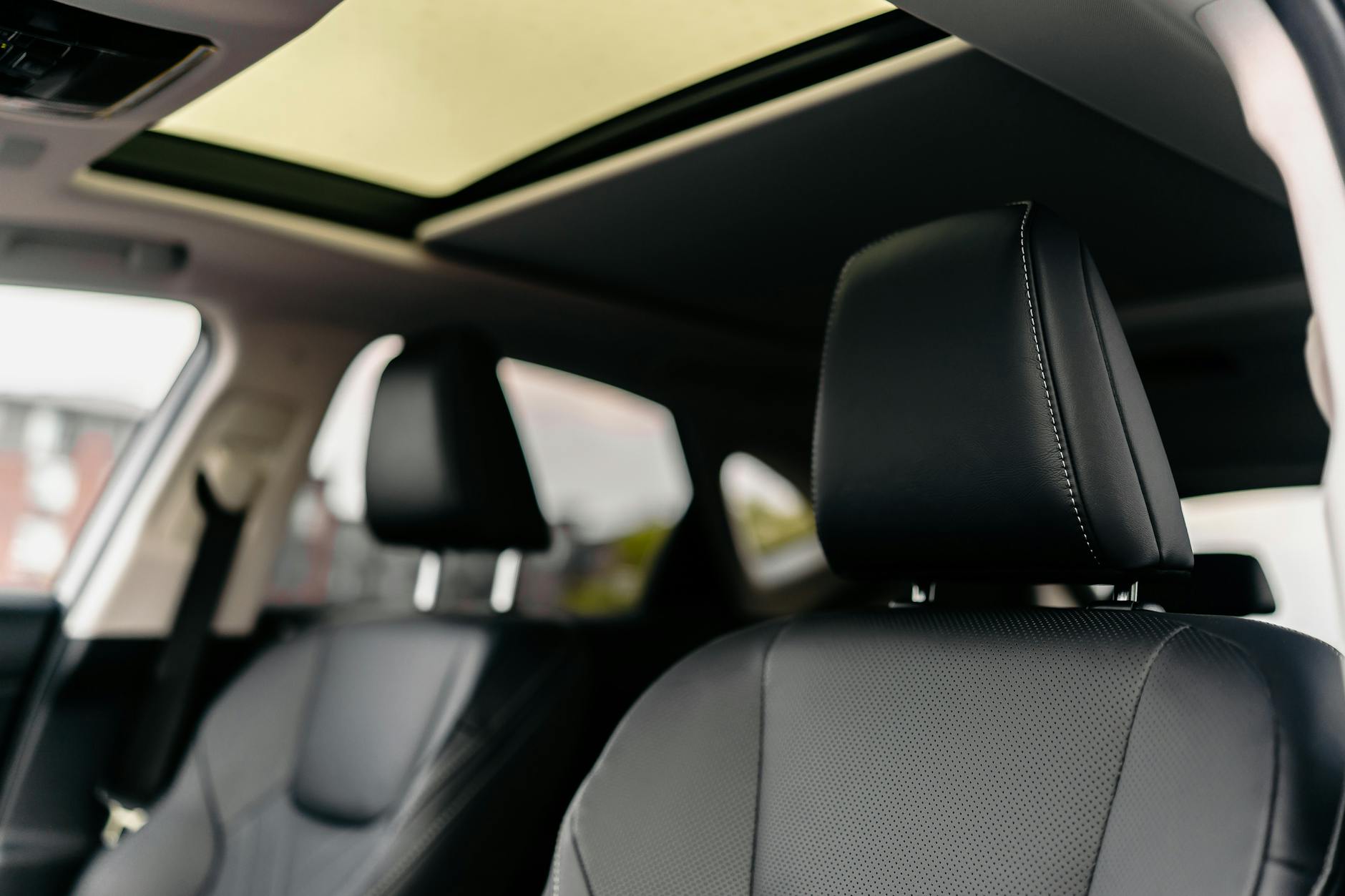 Luxury vehicle interior with black leather seats and panoramic sunroof, Volantis fleet