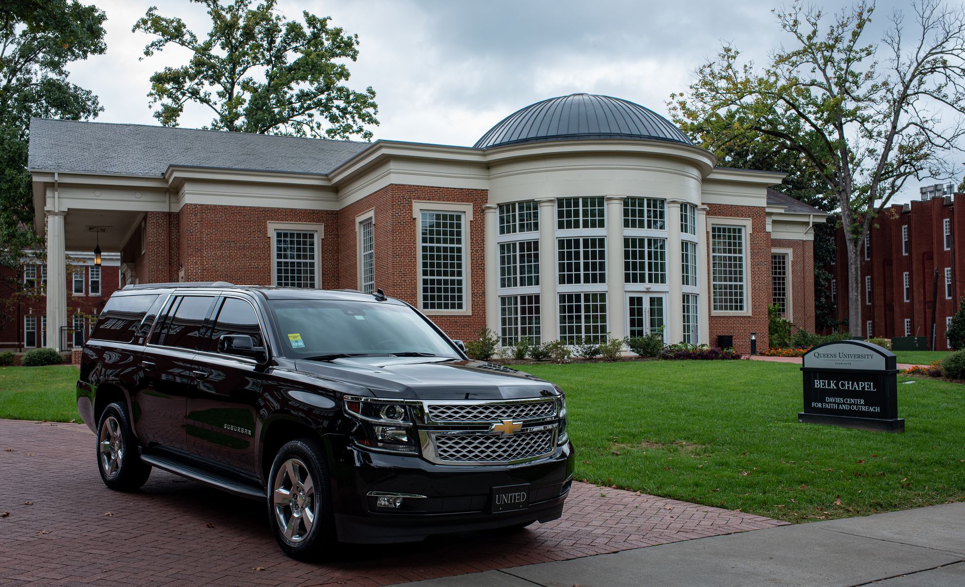 Black full-size SUV parked outside an elegant building, Volantis Limousine Services full-size SUV class